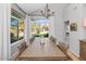 Bright dining room with a large window, wood floors, and modern lighting at 15020 S 25Th St, Phoenix, AZ 85048