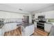 Well-lit kitchen featuring white cabinets, stainless appliances, granite counters, kitchen island, and hardwood floors at 15020 S 25Th St, Phoenix, AZ 85048