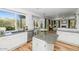 Bright, updated kitchen with granite countertops, white cabinetry, stainless steel appliances, island and backyard views at 15020 S 25Th St, Phoenix, AZ 85048