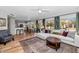 Open-concept living space with modern decor, wood floors, and seamless flow to the kitchen at 15020 S 25Th St, Phoenix, AZ 85048