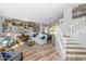 Bright living room with staircase, wood floors, abundant artwork, and view to the dining area at 15020 S 25Th St, Phoenix, AZ 85048
