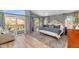 Spacious main bedroom with private balcony access, large windows, and hardwood floors at 15020 S 25Th St, Phoenix, AZ 85048