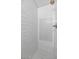 Modern shower with white subway tile, geometric accent wall, and gold fixtures at 15020 S 25Th St, Phoenix, AZ 85048