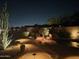 Backyard at night with gorgeous desert landscaping, a pool and manicured shrubs at 15107 E Desert Willow Dr, Fountain Hills, AZ 85268