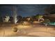 Backyard at night with landscape lighting and beautiful desert landscaping at 15107 E Desert Willow Dr, Fountain Hills, AZ 85268