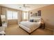 Bright bedroom featuring neutral walls, plush carpet, a ceiling fan, and a comfortable bed with stylish linens at 15107 E Desert Willow Dr, Fountain Hills, AZ 85268