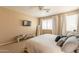 Cozy bedroom with a large bed, a wall-mounted TV, and windows providing ample natural light at 15107 E Desert Willow Dr, Fountain Hills, AZ 85268