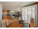 Open dining area with modern light fixture and view of kitchen and outdoor patio at 15107 E Desert Willow Dr, Fountain Hills, AZ 85268