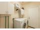Well-organized laundry room with modern appliances and ample storage space at 15107 E Desert Willow Dr, Fountain Hills, AZ 85268