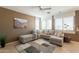 Comfortable living room with tile floors, a ceiling fan, and a large sectional sofa at 15107 E Desert Willow Dr, Fountain Hills, AZ 85268
