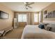 Spacious main bedroom with neutral tones, plush bedding, and decorative wall art at 15107 E Desert Willow Dr, Fountain Hills, AZ 85268