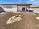Backyard space featuring desert landscaping and covered patio at 15369 W Wethersfield Rd, Surprise, AZ 85379