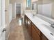 En-suite bathroom with double sinks, large mirrors, and shower-tub combination at 15369 W Wethersfield Rd, Surprise, AZ 85379
