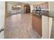 Bright open kitchen with tile floors, wooden cabinets, stainless steel appliances, and granite counters at 15369 W Wethersfield Rd, Surprise, AZ 85379