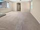 Spacious living room with neutral carpet and paint, and many windows allowing for natural light at 15369 W Wethersfield Rd, Surprise, AZ 85379