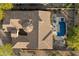 An aerial view of a home with a pool, patio, desert landscaping, and tile roof, in a residential community at 1713 W Calle Marita --, Phoenix, AZ 85085