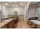 Bathroom featuring dual sinks, granite countertops, and a soaking tub with stone surround at 1713 W Calle Marita --, Phoenix, AZ 85085