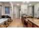Bathroom featuring dual sinks, granite countertops, tile floors, and a soaking tub at 1713 W Calle Marita --, Phoenix, AZ 85085