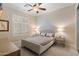 Bedroom featuring plantation shutters, carpeted floors, and modern furnishings at 1713 W Calle Marita --, Phoenix, AZ 85085