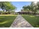 Community clubhouse with manicured lawn, covered walkway, and inviting entrance at 1713 W Calle Marita --, Phoenix, AZ 85085