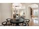 Bright dining area with an elegant chandelier and a view into the living room at 1713 W Calle Marita --, Phoenix, AZ 85085