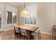 Bright dining area with a modern light fixture and natural light streaming in from the windows at 1713 W Calle Marita --, Phoenix, AZ 85085