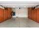Spacious garage with epoxy flooring, built in brown cabinets, and modern lighting, offering great storage and functionality at 1713 W Calle Marita --, Phoenix, AZ 85085