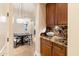 Hallway featuring granite countertop, wooden cabinets, and a view of the dining area at 1713 W Calle Marita --, Phoenix, AZ 85085