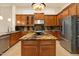 Gourmet kitchen boasts rich wood cabinets, granite countertops, stainless appliances, and a central island at 1713 W Calle Marita --, Phoenix, AZ 85085