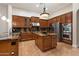 Gourmet kitchen boasts rich wood cabinets, granite countertops, stainless appliances, and a central island at 1713 W Calle Marita --, Phoenix, AZ 85085