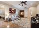 Living room with a large area rug, modern sofas, and a ceiling fan at 1713 W Calle Marita --, Phoenix, AZ 85085