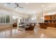 Open-concept living room featuring plantation shutters, comfortable seating, and seamless transition to the dining area at 1713 W Calle Marita --, Phoenix, AZ 85085