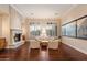 Bright living room with hardwood floors, fireplace, plantation shutters, and stylish decor at 1713 W Calle Marita --, Phoenix, AZ 85085