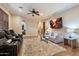 Living room with a large area rug, modern sofas, and a ceiling fan at 1713 W Calle Marita --, Phoenix, AZ 85085
