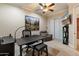 Bright office with a ceiling fan, modern desk, and comfortable seating at 1713 W Calle Marita --, Phoenix, AZ 85085