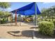 Community playground featuring shaded play structures, climbing area, and slide, ideal for Gathering fun at 1713 W Calle Marita --, Phoenix, AZ 85085