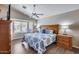 Bedroom featuring a beautiful window with blinds and two dressers on either side of the bed at 17162 N Winding Trl, Surprise, AZ 85374
