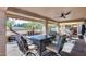 Featuring a large outdoor patio area with a custom dining set and tropical landscaping at 17162 N Winding Trl, Surprise, AZ 85374