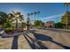 Attractive entrance to a community area featuring lush landscaping, a decorative fountain, and convenient parking at 17162 N Winding Trl, Surprise, AZ 85374