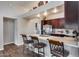 Open kitchen with bright lighting, stainless steel appliances, and a convenient breakfast bar seating area at 17162 N Winding Trl, Surprise, AZ 85374