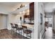Modern kitchen boasting white quartz countertops and dark wood cabinets, adjacent to breakfast bar at 17162 N Winding Trl, Surprise, AZ 85374