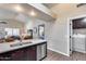 Open kitchen with stainless steel appliances, modern faucet, and view to the living room and bedroom at 17162 N Winding Trl, Surprise, AZ 85374