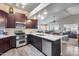 Modern kitchen with stainless appliances, white countertops, and dark cabinets at 17162 N Winding Trl, Surprise, AZ 85374