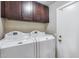 Laundry room featuring a washer and dryer and above storage cabinets at 17162 N Winding Trl, Surprise, AZ 85374