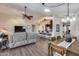 Open-concept living room with wood floors seamlessly connects to a kitchen and dining area at 17162 N Winding Trl, Surprise, AZ 85374