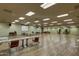 Large meeting room with tables, chairs, projector screen, and plenty of open space at 17162 N Winding Trl, Surprise, AZ 85374