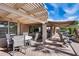 Inviting covered patio with ample seating, perfect for outdoor dining and relaxation in a tranquil backyard at 17162 N Winding Trl, Surprise, AZ 85374