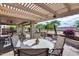 Outdoor patio and dining area, perfect for entertaining with lush tropical landscaping at 17162 N Winding Trl, Surprise, AZ 85374