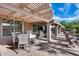 Covered patio with an open pergola, featuring a dining table and additional seating area at 17162 N Winding Trl, Surprise, AZ 85374
