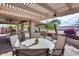 Spacious covered patio featuring an outdoor seating area, lush landscaping, and a serene ambiance for relaxing at 17162 N Winding Trl, Surprise, AZ 85374